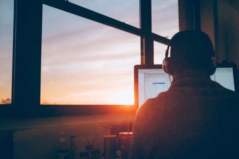 a man sitting in front of a computer screen