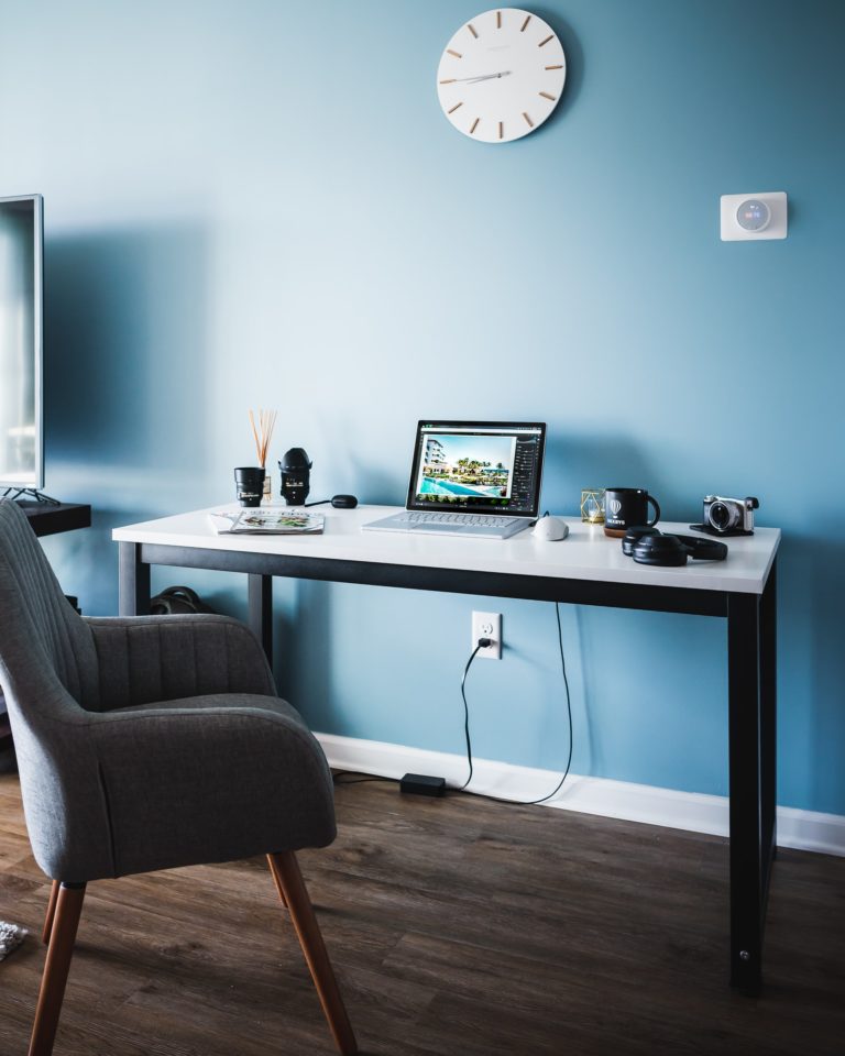 a desk with a computer and a chair