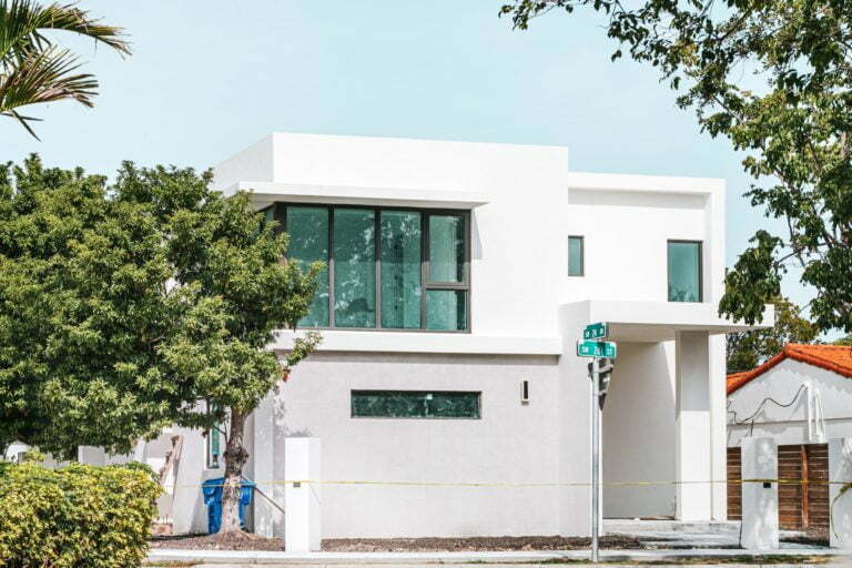 a white building with a tree in front of it