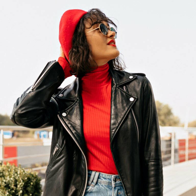 a person wearing a black jacket and red hat