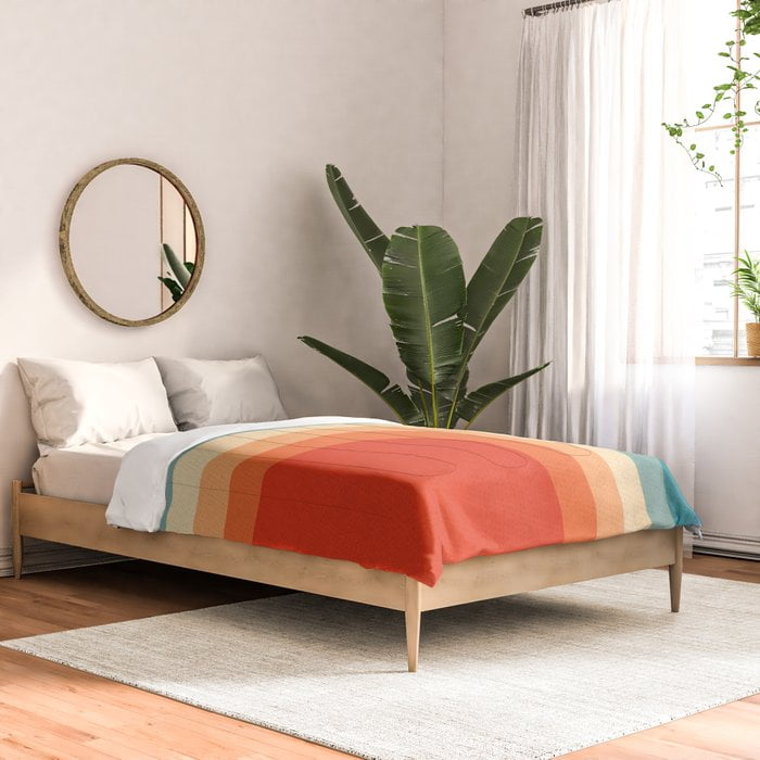 a bed with a plant in the corner
